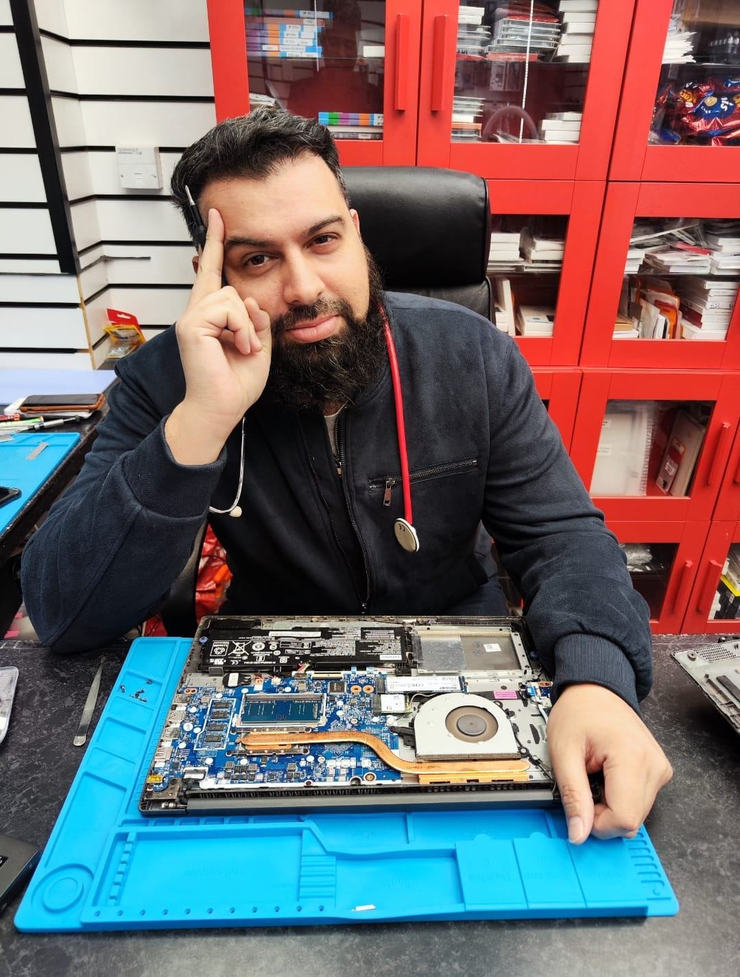fone doctors technician diagnosing a laptop on the repair bench